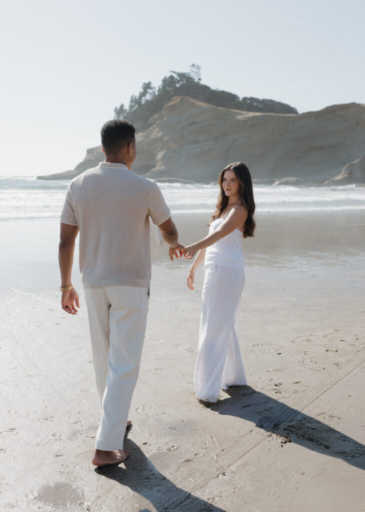 Romantic Cape Kiwanda couple by the ocean
Couple enjoying the sandy beach at Cape Kiwanda
Couple running along the beach at sunset
Parents holding their baby boy on Oregon Coast
Sweet family moment by the ocean at Cape Kiwanda
Dramatic cliffs along Cape Kiwanda shoreline
Sandstone rock formations on the Oregon Coast
Golden hour glow over Cape Kiwanda cliffs
Natural candid moments during Cape Kiwanda session
Cape Kiwanda sunset over the ocean