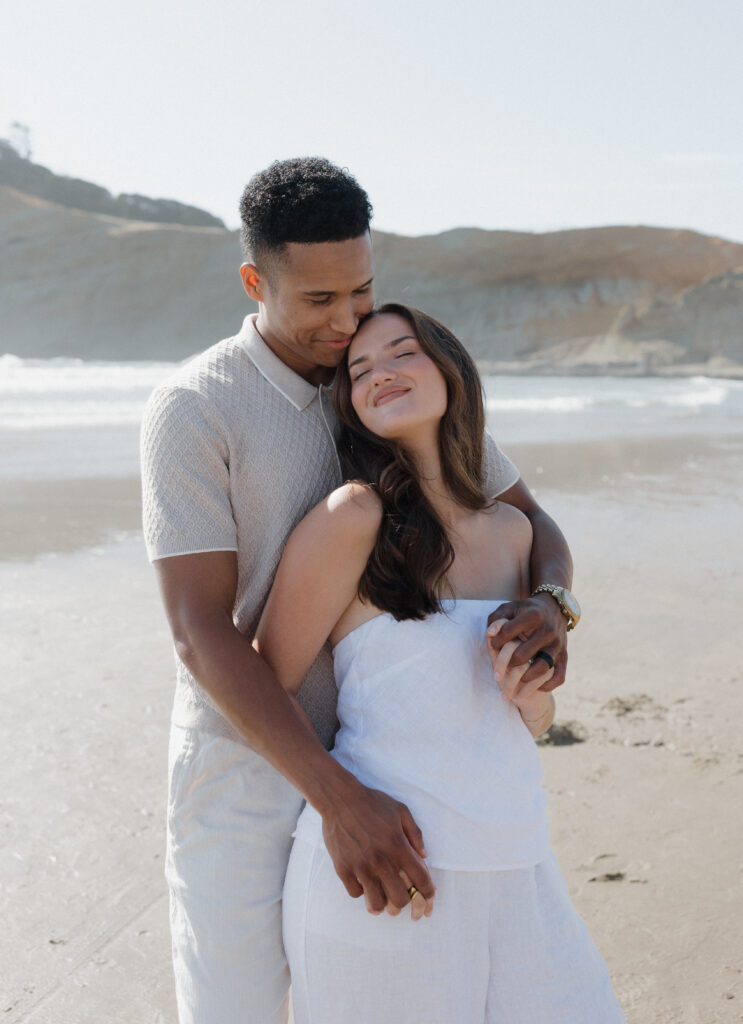 Romantic Cape Kiwanda couple by the ocean
Couple enjoying the sandy beach at Cape Kiwanda
Couple running along the beach at sunset
Natural candid moments during Cape Kiwanda session
Parents holding their baby boy on Oregon Coast
Sweet family moment by the ocean at Cape Kiwanda
Dramatic cliffs along Cape Kiwanda shoreline
Sandstone rock formations on the Oregon Coast
Golden hour glow over Cape Kiwanda cliffs
Cape Kiwanda sunset over the ocean