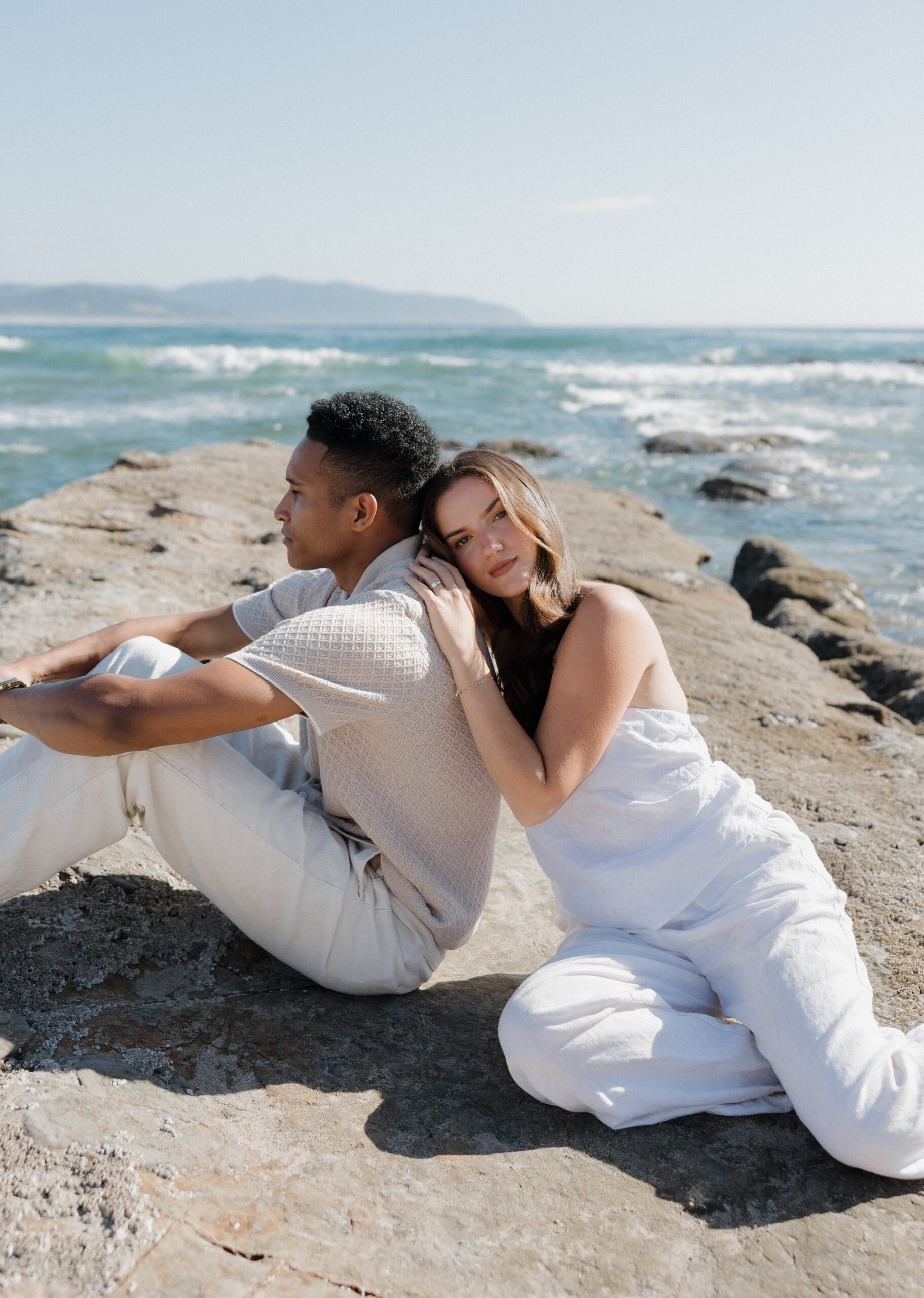 Romantic couple embracing on Cape Kiwanda shoreline with ocean cliffs Couple walking along Cape Kiwanda beach at sunset Couple sharing a playful moment at Cape Kiwanda Natural candid couple photography on Oregon Coast Parents holding their baby boy on Cape Kiwanda sand Sweet family moment by the ocean at Cape Kiwanda Intimate family photography at sunset on Oregon Coast Baby boy snuggled with parents on Cape Kiwanda beach Playful family interactions on Cape Kiwanda sand Cape Kiwanda towering rock cliffs by the ocean Dramatic cliffs and crashing waves along Oregon Coast Rugged coastal sandstone formations at Oregon Coast Golden glow over Cape Kiwanda coastal cliffs Sweeping ocean views from Cape Kiwanda shoreline Serene Cape Kiwanda coastal landscape with ocean