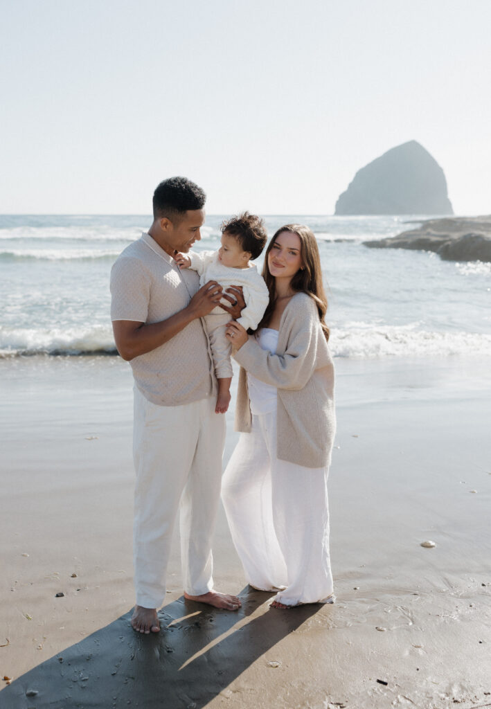 Cape Kiwanda romantic couple by the ocean  
Sandy beach couple enjoying the Cape Kiwanda shoreline  
Couple running along Cape Kiwanda beach at sunset  
Candid natural moments during Cape Kiwanda couples session  
Parents cuddling baby boy on Cape Kiwanda beach  
Sweet family moment by the Cape Kiwanda ocean  
Intimate family photography at Oregon Coast sunset  
Baby boy held close by parents on Cape Kiwanda shoreline  
Dramatic cliffs along Cape Kiwanda coastline  
Sandstone formations on the Oregon Coast  
Golden hour glow over Cape Kiwanda cliffs  
Tender moments between parents and baby on Oregon Coast  
Playful family time on Cape Kiwanda sand  
Warm coastal light along Oregon Coast  
Sunset over the ocean at Cape Kiwanda 