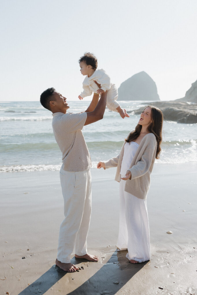Romantic Cape Kiwanda couple by the ocean  
Couple enjoying the sandy beach at Cape Kiwanda  
Couple running along the beach at sunset  
Natural candid moments during Cape Kiwanda session  
Parents cuddling their baby boy on the beach  
Sweet family moment by the ocean at Cape Kiwanda  
Intimate family photography at sunset on Oregon Coast  
Baby boy held close by parents at Cape Kiwanda  
Dramatic cliffs along Cape Kiwanda shoreline  
Sandstone rock formations on the Oregon Coast  
Golden hour glow over Cape Kiwanda cliffs  
Tender moments between parents and baby on Oregon Coast  
Playful family time on the sand at Cape Kiwanda  
Warm coastal light on the Oregon Coast  
Cape Kiwanda sunset over the ocean 