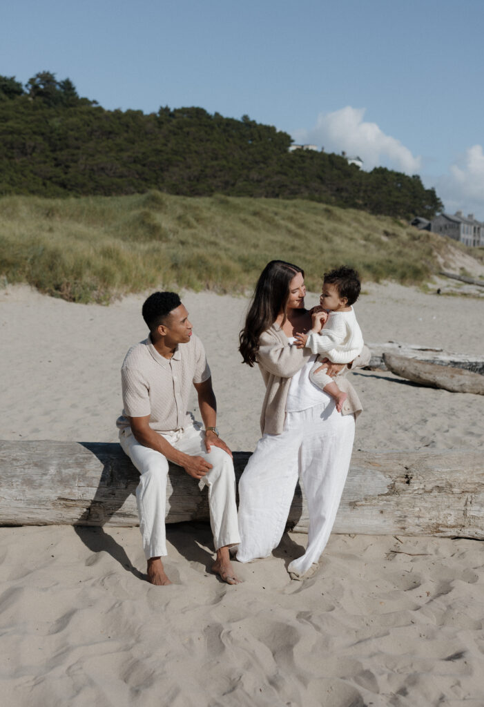 Loving couple embracing on Cape Kiwanda shoreline  
Joyful couple walking along the Cape Kiwanda beach  
Couple sharing a playful moment at sunset on Oregon Coast  
Intimate candid couple photography at Cape Kiwanda  
Parents holding their baby close by the ocean  
Family enjoying tender moments on Cape Kiwanda sand  
Parents laughing with baby on Oregon Coast  
Baby boy snuggled with parents on Cape Kiwanda beach  
Playful family interactions on Cape Kiwanda beach  
Sunset family portraits on Oregon Coast  
Majestic cliffs along Cape Kiwanda coastline  
Rocky sandstone formations at Oregon Coast  
Golden sunset light over Cape Kiwanda shore  
Warm evening glow along Oregon Coast coastline  
Ocean sunset behind couple at Cape Kiwanda